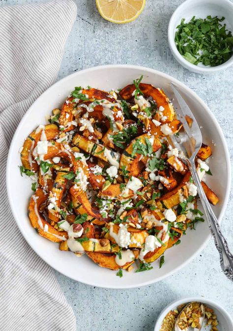 Sautéed delicata squash is like autumn on a plate! This easy recipe takes the delicious, naturally sweet delicata squash and cooks it in a bit of olive oil with aromatic spices. It is then garnished with shelled pistachios, salty feta cheese, green parsley leaves and lemon-tahini sauce. Great for gatherings or as a Thanksgiving side dish. Roasted Delicata Squash Salad, Delicata Squash Breakfast, Recipes For Delicata Squash, Squash Delicata Recipes, Delicate Squash Recipes, Shelled Pistachios, Squash Side Dish, Delicata Squash Recipe, Lemon Tahini Sauce