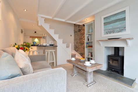 One bedroom cottage renovated with care and passion. Calm and muted palette against bright, white walls make this refurbished fisherman's cottage light and airy. Good use of original features give this cosy property real character such as the woodburner in the original fireplace and exposed granite wall. Seaside Cottage Interior, Fisherman Cottage, Small Cottage Interiors, Cornwall Cottage, Cottages Interiors, Cornish Cottage, Luxury Cottages, Cornwall Cottages, Fishermans Cottage