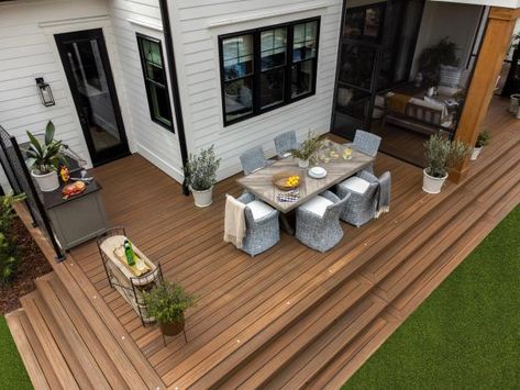 The outdoor dining space provides room for a larger gathering and a small buffet zone to place food and drink when entertaining a crowd. Deck Ideas For Small Backyards, Hgtv Smart Home 2022, Grill Deck, Ideas For Small Backyards, Backyard Deck Ideas, Small Backyards, Trex Deck, Deck Designs Backyard, Deck Projects