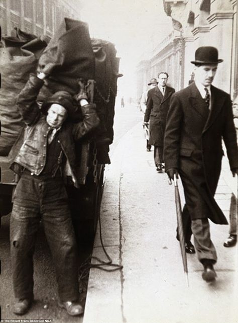 Contrast: Robert Frank used his pictures to document the stark differences between high and low strata of society. In this image, his composition juxtaposes a man delivering coal with well-dressed men in long coats and hats Robert Frank Photography, Cultural Photography, Incredible Pictures, London Pride, Robert Frank, The Americans, London History, Long Coats, Old London