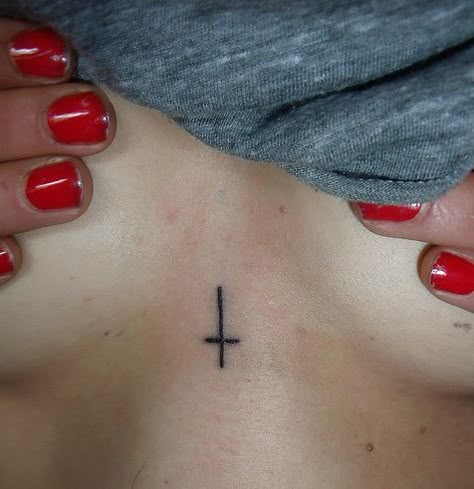 This symbol actually means humility towards Christ. When Peter was executed, he asked for the cross to be turned upside down because he felt that he wasn't worthy to die the same way that Christ did. Educate yourself. Cross Between Chest Tattoo, Satanic Tattoos, Upside Down Cross, Forearm Tattoo Quotes, Small Chest Tattoos, Occult Tattoo, Chest Tattoos For Women, Poke Tattoo, Cross Tattoo