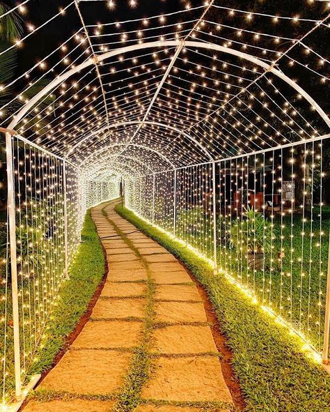 Entering into the beautiful phase of life under the stars... literally. We'd ❤️ to walk under this tunnel of lights and take a few 100… Diy Wedding Entrance, Entrance Walkway, Tunnel Entrance, Wedding Walkway, Outdoor Wedding Lighting, Event Entrance, Entrance Lighting, Wedding Hall Decorations, Wedding Background Decoration