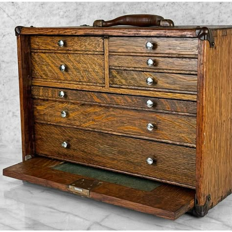 Antique Quartersawn Oak Machinist Chest Tool Box, c. Early 20th Century      - Pairs Nicely with Many Traditional & Eclectic Interior Styles     - Crafted of Solid Oak with an Attractive Quartersawn Grain Throughout     - Raised Panel Drop Down (and Store Away) Front     - Misc Sized Storage Drawers with Nickel Pulls     - Original Aged Leather Top Handle     - Exposed Joinery Corners with Decorative Ormolu Mounts     - Unsigned or Marked Antique Sewing Tools, Antique File Cabinet, Gerstner Tool Chest, Machinist Tool Box, Wood Tool Chest, Apothecary Chest, Portable Tool Box, Antique Oak Furniture, Old Tool Boxes