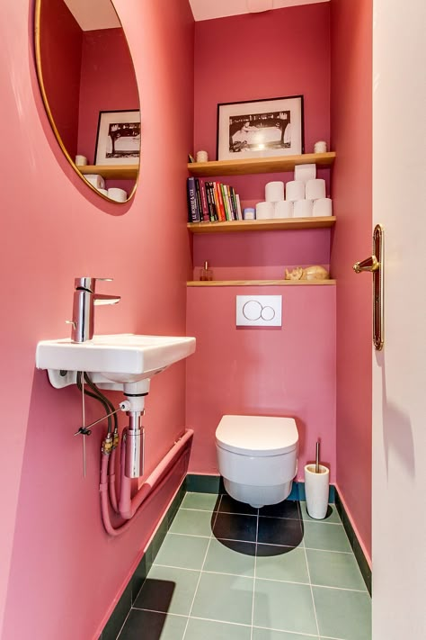 Pink and snazzy powder room with glossy tiles that bring brightness to the space - Decoist Bright Toilet Design, Bright Toilet Room, Small Pink Toilet Room, Colorful Toilet Room, Pink Downstairs Toilet, Powder Toilet Design, Small Toilet Room Ideas Modern, Peach Toilet, Pink Toilet Room