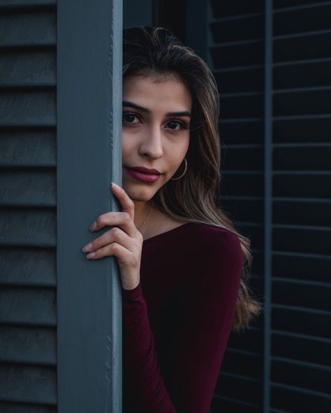 Mysterious looking girl wearing a red top hiding behind a blue wooden door Hiding Reference, Door Poses, Sketchbook Inspo, School Paper, Hidden Door, Poor Children, Woman Standing, Red Top, Girls Wear