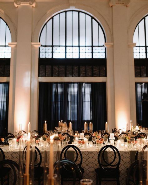 Dreamy wedding reception setup featuring elegant black infinity chairs, modern linens, lux tableware, custom signage and lush florals dotted with moody candles and jazz-club lamps. All this under a twinkly 24 foot wide gold chandelier. Perfectly capturing the chic, speakeasy feel that N&R love. photographer: @joshua_kane_photography Jazz Club Wedding, Speakeasy Wedding Reception, Moody Candles, Dreamy Wedding Reception, Wedding Reception Setup, R Love, Custom Signage, Jazz Club, Gold Chandelier