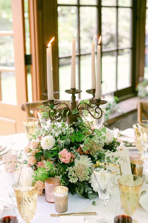 An garden wedding reception in a greenhouse, needs a whimsical garden style flower centerpiece. With a metal candelabra with taper candles in the center, we designed the floral around the base using the best PNW summer flowers we could find especially ferns and dahlias. Summer Wedding Flowers Centerpieces, Blush Wedding Reception, Pnw Summer, Floral Chuppah, Summer Wedding Floral, Tent Wedding Reception, Blush Wedding Colors, Candle Flower, Candelabra Centerpiece