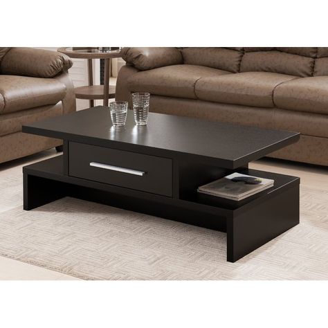 Center your well-appointed living room or den seating group in simple style with this essential coffee table, the perfect balance of clean-lined, loft-worthy looks and effortless utility in your ensemble. Defined by a simple manufactured wood design with classic woodgrain details, this piece offers a neutral touch to your look, while its open side shelves, wide drawers, and metal bar pull add a dash of definition and contemporary appeal to the space. Top it off with a spread of glossy fashion ma Wooden Coffee Table Designs, Centre Table Living Room, Centre Table Design, Meja Sofa, Sofa Table Design, Drawer Coffee Table, Tea Table Design, Center Table Living Room, Central Table