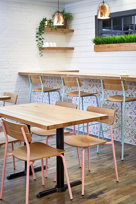 Pink and light blue restaurant chairs fill this colorful brunch bar in Grand Rapids. Cafe Table Chair Design, Restaurant Table Chair Design, Cafeteria Tables And Chairs, Restaurant Table And Chair Design, Restorent Table Design, Restaurant Tables And Chairs Ideas, Tables And Chairs For Cafe, Restaurant Table Ideas, Table And Chairs For Restaurant