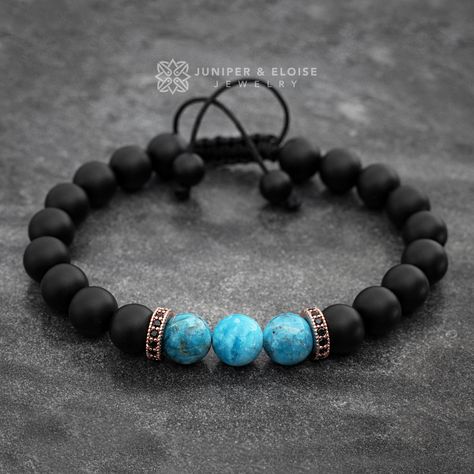 Handmade bracelet made with 8 mm Black Matte Onyx and blue Apatite beads, featuring 2 rose gold plated spacer rings embellished with black zircon stones. It's  adjustable, utilizing a sliding knot made with macrame cord and is easy to put on and take off by yourself.  All of our jewelry comes in luxury jewelry box and black velvet pouch, ready to gift. All bracelet models can be customized as stretch or adjustable for the same price.  You may have a piece created just for you. Please send messag Mens Onyx Bracelet, Spacer Rings, Ring Spacer, Black Beaded Bracelets, Bracelet Mens, Jewelry Showcases, Jewelry For Men, Sliding Knot, Onyx Bead