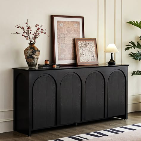 Simple style has a pure aesthetic feeling, with no complicated carving, comfort has always been very simple. The black color is simple and elegant. This sideboard buffet has a large surface to display framed photographs, creative accents, and more. Four doors open to reveal ample storage for dining linens and plates. Black Dining Sideboard, Styling Black Sideboard, Dining Room With Buffet Cabinet, Side Boards And Buffets Living Room, Moody Sideboard, Buffet Styling Dining Room, Entry Decor Ideas Entrance, Side Board Decor Ideas, Entry Buffet