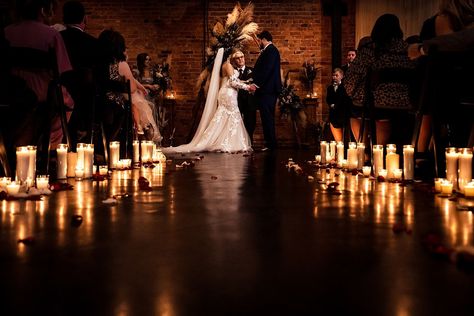 candle-lit wedding ceremony at Brick & Mortar events with backdrop made by friends and family of the couple Candlelight Wedding Ceremony Outdoors, Brick Wedding Ceremony, Dim Lit Wedding Ceremony, Indoor Candlelight Wedding, Candle Lit Isle Wedding, Candle Lite Wedding Ceremony, Candle Lit Weddings, Candle Lit Wedding Reception Romantic, Candle Lit Wedding Ceremony