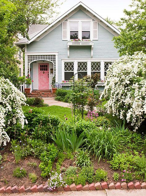 Consider adding details that don't cost a lot but pay off big on cottage-style homes' front yards. Here, those include window boxes at both lower and second-story windows, as well as a trellis pattern repeated around the front door and on those containers. Cottage Exteriors, Small Front Yard Landscaping, Small Front Yard, Cottage Style Home, Into The West, Cottage Exterior, Cottage Style Homes, Pink Door, Front Landscaping