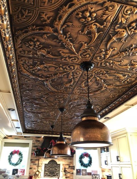 a pressed tin metal ceiling shows off a beautiful vintage pattern that adds an exquisite touch to the space Ceiling Metal Design, Tin Ceiling Tiles Bathroom, Kitchens With Tin Ceilings, Rustic Metal Ceiling Ideas, Tin Ceiling Tiles Kitchen Backsplash, Antique Ceiling Design, Unique Ceiling Ideas Living Room, Tin Ceiling Ideas Rustic, Tin Ceiling Ideas