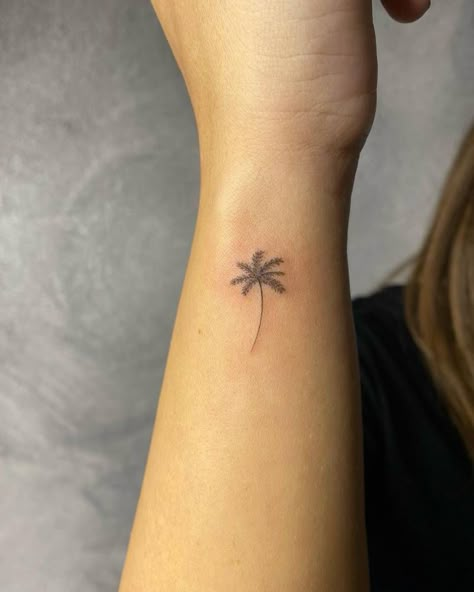 Single needle palm tree tattoo on the wrist Palm Tree Tattoo Side Of Wrist, Small Palm Tree Tattoo Wrist, Palm Tree Tattoo On Wrist, Wrist Palm Tree Tattoo, Palm Tree Wrist Tattoos For Women, Palm Tree Wrist Tattoo, Palm Tree Fine Line Tattoo, Sri Lanka Tattoo Ideas, Mini Palm Tree Tattoo