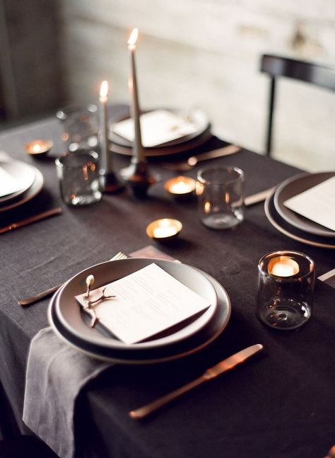 This is the great example of sticking to an overall dark color palette. We love how the gray table and glassware looks against back votive holders and black linens. Black Tablecloth Wedding, Black Wedding Table, Pillar Candles Wedding, Black Wedding Decorations, Wedding Candles Table, Black Tablecloth, Grey Table, Simple Photo, Wedding Table Settings