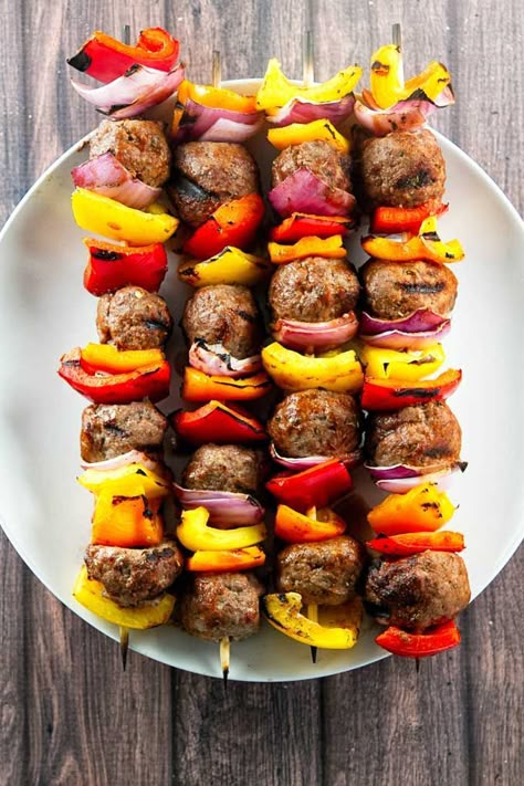 Grilled Italian Beef Skewers with fresh bell peppers, red onion, and homemade meatballs. The meatballs are brushed with a simple tomato glaze that takes about two minutes to mix-up! This is the best kind of summer comfort food. Pop over to my site for the recipe! | dinner ideas | ground beef recipes | summer recipes | Meatballs Beef, Meatball Skewers, Juicy Meatballs, Kabob Skewers, Beef Skewers, Kabob Recipes, Italian Beef, Beef Meatballs, Homemade Meatballs