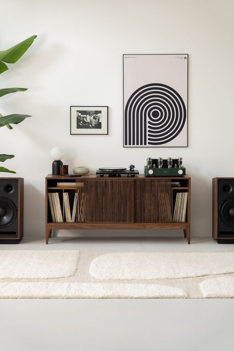 The TONN 150 record player stand, expertly crafted from durable American walnut wood, designed specifically to enhance your vinyl record collection. It impresses with its minimalist form, yet stands out for its functionality. Customize the interior of the TONN 150 record player stand according to your preferences using adjustable shelves and visually appealing cotton cords, ensuring an organized display of your vinyl collection. Strategically placed openings at the back of the cabinet enable eff Walnut Tv Stand, Record Turntable, Turntable Stand, Record Player Stand, Vinyl Record Collection, Solid Wood Sideboard, Vinyl Record Storage, Record Storage, Wood Cover