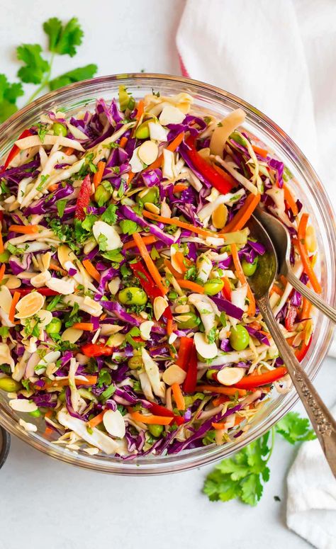 This crunchy Asian Cabbage Salad is colorful, healthy, and absolutely delicious! Made with raw cabbage, carrots, edamame, and almonds, it's topped with an addictive ginger peanut dressing. The perfect healthy side dish for potlucks or leftover for quick and easy lunches. Cabbage Salads, Chinese Cabbage Salad, Asian Ramen Salad, Asian Cabbage Salad, Asian Cabbage, Asian Salad Recipe, Asian Salad Dressing, Raw Cabbage, Red Cabbage Salad