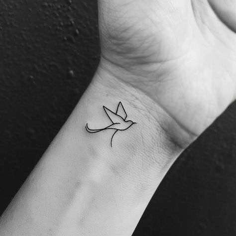 Discover the elegance of simplicity with this black ink bird tattoo, symbolizing freedom and the journey of life. Save and follow for more minimalist art inspiration. Captured in the delicate outline of a swallow in mid-flight, this tattoo embodies the spirit of adventure and the beauty of expression in its most unadorned form. Let the wings of this graceful creature remind you of the endless skies waiting to be explored. #MinimalistTattoo #BirdInk #FreedomSymbol #ArtInspiration # Tattoo Letting Go Symbol, Minimal Bird Tattoo, Small Swallow Tattoo, Minimalist Bird Tattoo, Bird Outline Tattoo, Golondrinas Tattoo, Bird Tattoo Design, Tattoo Swallow, Bird Outline