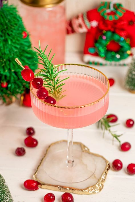 Pink Holiday Cocktail - Mixop Pink Mascoto Drinks, Pink Holiday Cocktail, Pink Sparkly Cocktail, Pink Cocktail Glasses, Pink Cranberry Juice Cocktails, Pink Drink Cocktail, Pink Christmas Drink, Pink Batch Cocktail, Pink Christmas Cocktail