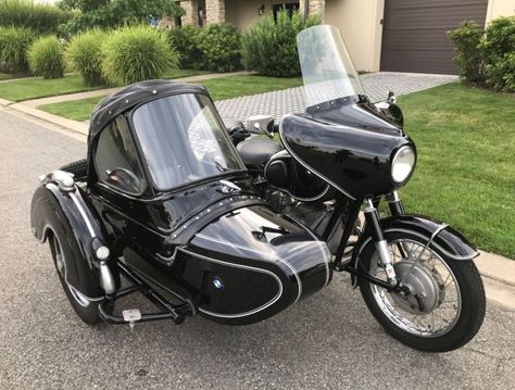 Here’s a combination of two German-made black beauties – a BMW R50/2 paired with a Steib TR500 sidecar. The TR500 was built specifically to be attached to bigger bikes like the offerings from Zundapp and BMW. It’s not as pretty as the bullet-shaped “S” models, but it was comfortable and rugged, which is why it was also used in service applications for local governments. Motorcycle With Sidecar, Classic 350 Royal Enfield, Bike With Sidecar, Bicycle Sidecar, Three Wheel Bicycle, Ural Motorcycle, Bike Bmw, Van Conversion Interior, Motorcycle Sidecar