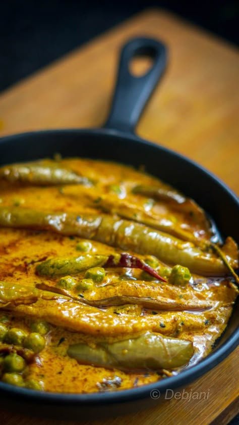 strips with ½ Tsp. of Turmeric Powder, ½ Tsp. of Kashmiri Red Chili Powder, ½ Tsp. of Sugar, and also ½ Tsp. of Salt. Heat the oil in a Pan and fry the eggplants at low temperature from all sides. Strain the fried Eggplants from the pan. Temper the oil with nigella seed and 2 dry red chilies. Add the mustard and curd mixture to it. Add Green Peas followed by green chilies as well and bring it to a boil. Now add Turmeric powder, sugar, red chili powder, and also salt. Now add fried Eggplants ... Green Brinjal Recipes Indian, Green Mustard Recipe, Best Indian Vegetarian Recipes, Dry Vegetable Recipe, Pan Fried Veggies, Eggplant Recipes Healthy, Green Eggplant, Eggplant Dishes, Bengali Food