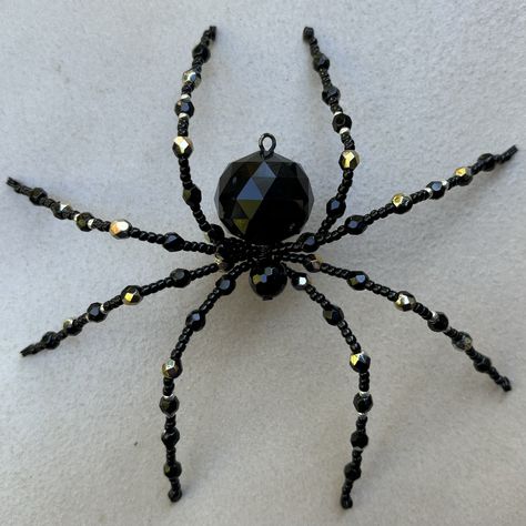 This striking Jet Black 'Marea' Beaded Spider is a unique piece of handcrafted art that adds an elegant touch to any space. Made with high-quality black 'marea' beads featuring a stunning metallic wash, paired with jet black beads, this spider captures the beauty of darkness with a touch of shine. Perfect as a statement piece in your home decor, a unique Halloween ornament, or a gift for someone who loves gothic or steampunk aesthetics. Each spider is meticulously crafted to ensure both durabili Beaded Spider Web, Bead Spider Web, Diy Bead Spiders, Spider Beads, Bead Spider Tutorial, Beaded Insects, Bead Spider, Bead Spiders, Spider Ornaments