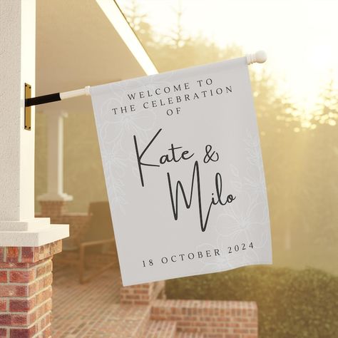 Welcome your guests in style with this elegant, personalized wedding celebration flag. Featuring a soft cream background and customizable with the names of the happy couple, this flag is a beautiful addition to any wedding venue. The delicate floral accents and sleek typography create a sophisticated and inviting look. Available in two sizes, 12" x 18" and 24.5" x 32", this weather-resistant flag is perfect for outdoor ceremonies, receptions, or as a keepsake to remember your special day. Sleek Typography, Garden House, Cream Background, Wedding Celebration, Outdoor Ceremony, Saint Louis, Happy Couple, The Happy, Garden Flags