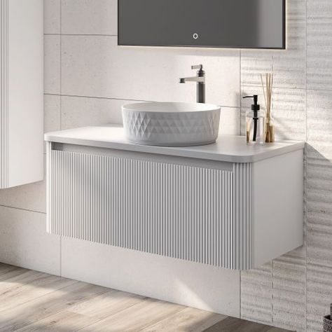 The Wish Ribbed Wall Hung Bathroom Vanity Unit makes for a stunning addition to any modern bathroom with its on-trend design, featuring meticulous fluted detailing. This white bathroom vanity unit combines functionality with aesthetic appeal, creating a harmonious blend of style and practicality.  The striking white ribbed design brings a unique and sophisticated look to the bathroom as well as a tactile element, it’s sure to be the focal point.   This fluted vanity unit houses a spacious soft c White Bathroom Sink Cabinet, Ribbed Bathroom Vanity, Wall Hung Vanity Unit, Ribbed Vanity, Fluted Bathroom Vanity, Furniture Detailing, Fluted Furniture, Ribbed Wall, Fluted Vanity