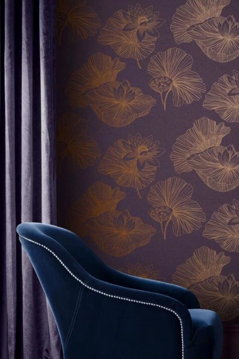 Symbolizing purity and beauty, the Lotus flower takes the main focus in this stunning wallpaper design. Rich textured purple substrate is adorned with luxurious copper metallic detailing, to give a regal, opulent feel. Combine with copper accessories and moody plum paint to create a sophisticated decor. #interiordesign #design #interior #homedecor #wallpaper #home #decor #interiors #homedesign #luxury #inspiration #renovation #housegoals #houseenvy #homeinspo  @SamanthaBlack #BlkApproved Plum Paint, Plum Wallpaper, Lotus Wallpaper, The Lotus Flower, Wallpaper Theme, Copper Accessories, Wall Material, Purple Theme, Metallic Texture