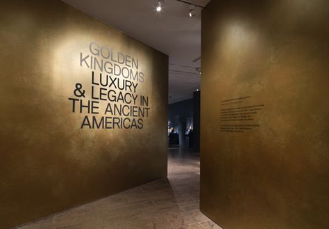 View of the entrance to the exhibition 'Golden Kingdoms: Luxury and Legacy in the Ancient Americas' Exhibition Entrance Design, Exhibition Entrance, Large Walls, Event Booth Design, Event Booth, Gold Wall Art, Entrance Design, Entrance Gates, The Exhibition