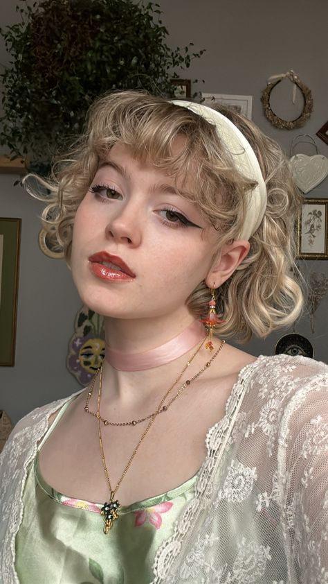 Girl wearing flower jewelry, a green slip dress, and lacy cardigan looking sideways with mouth partially open Cottagecore Hair Color Ideas, Cottagecore Hairstyles Short Curly, Cottagecore Hairstyles Short, Cottagecore People, Cottage Core Hairstyles, Pink Hair Styles, Cottage Core Hair, Cottagecore Hairstyles, Curly Pink Hair