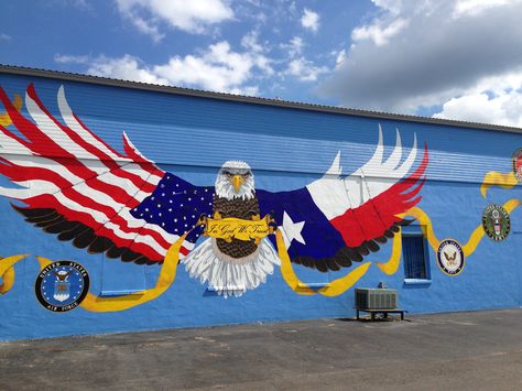 2014 "Patriot Mural" - 405 N Key Avenue, Lampasas, TX this 20' x 83' mural depicts a freedom eagle, talons grasping a ribbon with the words "In God We Trust".  Along the ribbon are patches of branches of service and first responders.    The mural was painted in 600 hours totally with volunteer labor and the assistance from local veterans, first responders, active-military and their families.   In addition a $500 donation was made to the Wounded Warriors project. Veterans Day Paintings, Patriotic Mural, Veteran Painting, Veteran Artwork, Veterans Day Collaborative Art, Veteran Sublimation Designs, Wounded Warrior Project, Wounded Warrior, Eagle Design