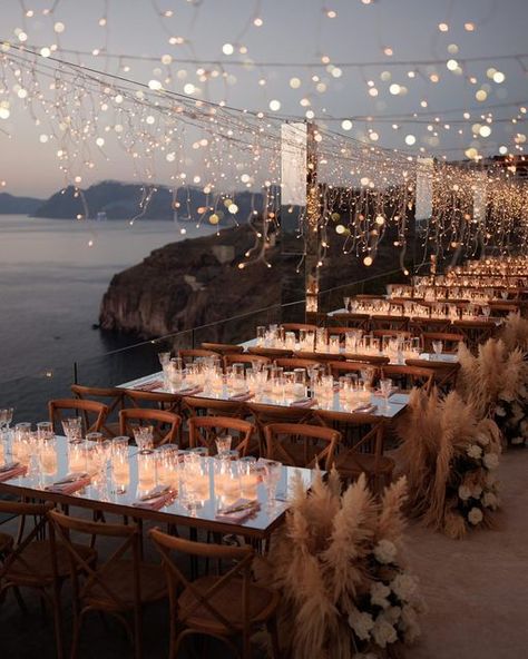 Julia & Evita on Instagram: "December 1st & it’s the perfect time to share with you the day we covered the entire balcony of Cavo Ventus with fairy lights, for Carina & Simon’s reception dinner 💛✨ Only with our favourite @whiteonblackstudio 😍 . . . #santoriniwedding #weddinginsantorini #greecewedding #weddingingreece #greeceweddingplanner #fairylights #fairylightsdecor #pampas #pampasgrass #pampasgrasswedding #summerwedding #weddingmoments" Garden Wedding Reception Outdoor, Fairy Lights Wedding Reception, Wedding Reception Outdoor, Luxury Event Decor, Fairy Lights Wedding, Wedding Reception Lighting, Dream Wedding Reception, Rustic Garden Wedding, Lights Wedding Decor