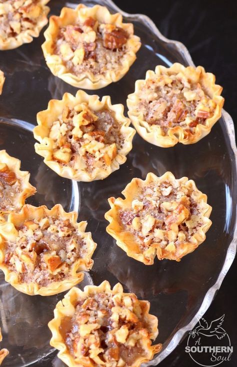 Pecan Pie Tart Bites are a fun little treat loaded with all the flavor of a regular slice of pie! Easy to make with the help of store bought phyllo cups, this dessert comes together in less than 15 minutes. Philo Dough, Pecan Pie Tarts, Pecan Pie Bites, Phyllo Recipes, Super Bowl Recipes, A Southern Soul, Phyllo Cups, Pie Easy, Pecan Tarts