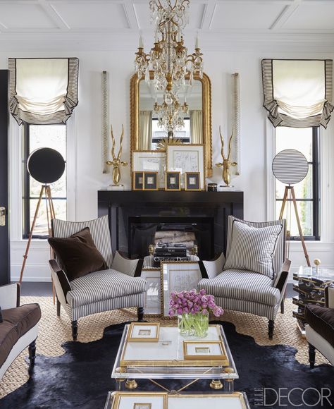 The living room armchairs, covered in a Rogers & Goffigon stripe, and cocktail tables are by Megan Winters Collection, the vintage chandelier is by Baccarat, the mirror was found in Paris, and the floor lamps are made from antique surveyor tripods; the linen wallcovering is by Ralph Lauren Home.   - ELLEDecor.com A Living Room, Fireplace, Coffee Table, Living Room, Coffee, Furniture