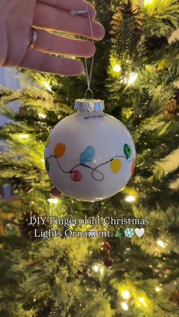 Jules | DIY baby + toddler photos • Motherhood on Instagram: "DIY Fingerprint Christmas Lights Ornament 🎄❄️🤍   Want to do this with your littles?  Make sure you’re following @diyphotoshootmom and comment DIY ORNAMENT and I’ll send you the step-by-step directions and the supplies I used to DIY your own special fingerprint Christmas lights ornament to cherish and hang on your Christmas tree    Make sure you’re following to receive the link!   Christmas crafts / Christmas gifts / diy ornament / keepsakes / diy mom / baby keepsakes / Christmas baby / toddler crafts / Christmas with kids / first Christmas / baby’s first Christmas / first time mom / pregnant / christmas ornament / special ornament / diy ornament ideas" Christmas Ornament Crafts Clear Ball, Fingerprint Christmas Ornaments Kids, Toddler Christmas Handprint Ornament, Baby Hand Christmas Ornament, Fingerprint Lights Ornament, Christmas Craft Ornaments For Toddlers, Baby Footprint Christmas Tree, Baby Fingerprint Ornament, Finger Print Christmas Tree Ornament