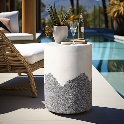 Upgrade your outdoor seating area with a stylish and sturdy cement side table that boasts a unique ombre-style finish. The table is perfectly designed to complement your modern decor and is built to last with durable materials. The gray and white color combination adds a touch of sophistication to your space, making it perfect for both indoor and outdoor use. With this round side table, you can enjoy a functional and visually appealing addition to your furniture collection. | Wade Logan® Gray & Cement Side Table, Stool Plant Stand, Patio Side Table, Round Accent Table, White Cement, Outdoor Furniture Decor, Drum Table, Outdoor Side Table, Round Side Table