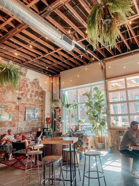 Greenery in coffee shop Coffee And Boutique Shop, Coffee House Astethic, Coffee Shop Aesthetic Industrial, Aethstetic Coffee Shop, Indoor Outdoor Coffee Shop, Small Cafe House Design, Local Coffee Shop Ideas, Plant Store Coffee Shop, Retail And Coffee Shop