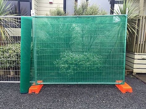 A green shade cloth is installed on the temporary fencing. Temporary Fencing, Shade Cloth, Pipe Sizes, Fence Panels, Wall Board, Construction Site, Galvanized Steel, Fencing, Shades Of Green