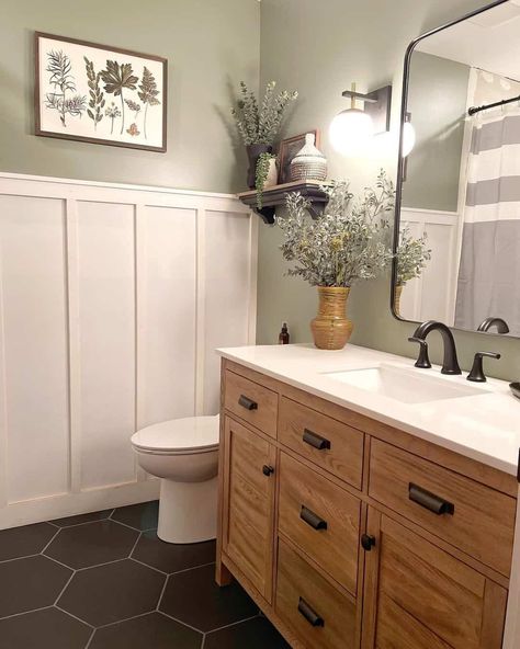 A fan favorite for bathrooms is a black hexagon tile with gray grout, especially in modern bathrooms. They look particularly upscale and trendy beside a board and batten wall and an updated vanity cabinet. These tiles can be made in other colors, but the matte black finish is very chic, especially when worked in with wooden accent pieces...   Image: thebradfordhouse Black Hexagon Tile, Gray Grout, Batten Wall, Farmhouse Flooring, Board And Batten Wall, Hexagon Tile, Spare Bathroom, Tiles Floor, Bath Tiles