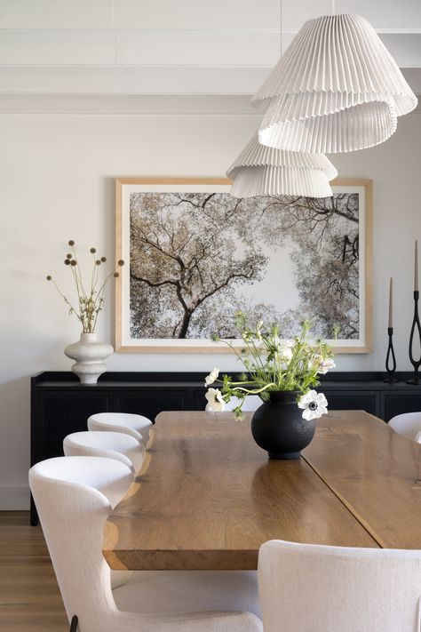 Dining Room With Art, Neutral Dining Room Round Table, White Dining Room Inspiration, Dining Next To Kitchen, Dining Room With Light Wood Floors, Dining Table Black Vase, Kitchen Into Dining Room Layout, Dining Room Design Inspiration, Tv In Dining Room Ideas