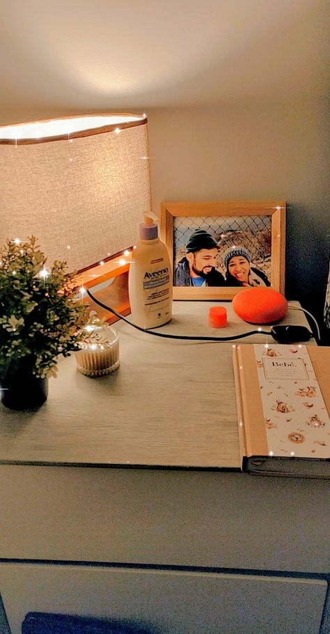 One way to style up a bedside table with a few essentials:  Table lamp, Plant, Candle, Diary, Google home, Moisturizing lotion, Lip balm, Photo frame 💙 Lamp Plant, Plant Candle, Bedside Table Decor, Moisturizing Lotion, Family Picture, Table Ideas, Moisturizing Lotions, Google Home, Family Pictures