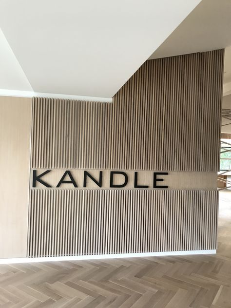 Wall Signage Design, Vertical Slats Wall, Black Fireplace Surround, Lobby Designs, Modern Wall Paneling, Spa Room Decor, Lobby Wall, Medical Office Design, Wall Signage