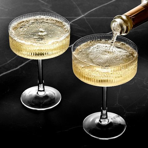 Ribbed vertical bands accentuate the modern, linear silhouette of our mouth-blown glassware. With their wide bowls and straight edges, these expertly crafted coupe glasses are ideal for serving sparkling wine and classic cocktails. Each one features a faceted design that brilliantly reflects the light to showcase your favorite beverages. Sold individually or as set of 4. Crafted of mouth-blown, fire-polished glass. Faceted exterior with smooth interior. Coordinates with other pieces in our Moder Textured Wine Glasses, Elegant Drinking Glasses, Coup Glasses Cocktails, Hammered Glassware, Nice Wine Glasses, Coup Glasses, Dinner Glasses, Fancy Wine Glasses, Modern Glassware