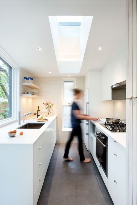 This small kitchen has white cabinets and plenty of windows to allow natural light to brighten the space and make it feel larger. #SmallKitchen #WhiteKitchen #Skylight Laneway House Interior, Contemporary Kitchen Ideas, Flat Front Cabinets, Laneway House, Suite Design, Traditional Colonial, Living Magazine, House Inside, Beautiful Interior Design