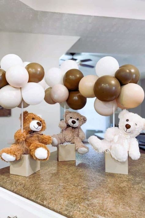 Discover charming teddy bear centerpiece ideas for your next baby shower or child's first birthday. Learn how to craft floating teddy bears with balloons, create adorable hot air balloon settings, and incorporate flowers for a soft, whimsical touch. These DIY decorations are easy to assemble with supplies from your local Dollar Tree, making them affordable yet unforgettable. Teddy Bear Wrapping Ideas, Bear Centerpiece Ideas Diy, Floating Teddy Bear Balloon, Bear Centerpiece Ideas, Bear Centerpieces, Bear Centerpiece, Teddy Bear Centerpieces, Teddy Bear Baby Shower Theme