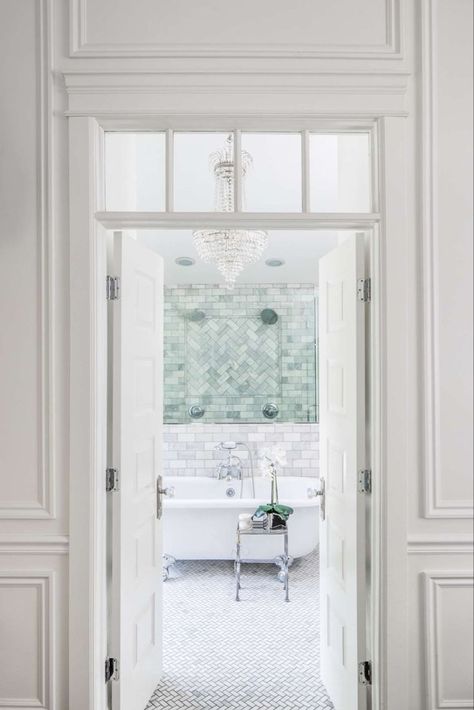 Elegant entry to a classic white bathroom. French doors with interior transom and paneled molding open to a marble bath with clawfoot tub and empire style crystal chandelier. Design by The Fox Group. #elegantdecor #bathroomdesign #traditionalstyle #classicbathroom #frenchdoors Bathroom Classic Design, Bathroom French Doors, The Fox Group, Classic White Bathrooms, Fox Group, Timeless Interior Design, French Country Bathroom, Timeless Interior, Bathroom Design Inspiration