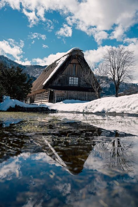 A thatched-roof house and its reflection on the water in Shirakawago. Gassho Zukuri, Shirakawa Go, Heavy Snowfall, Praying Hands, Gifu, A Fairy Tale, Mendoza, Unesco World Heritage Site, Unesco World Heritage